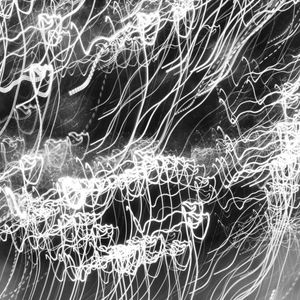 Abstract light trail photography suggesting fluid movement.