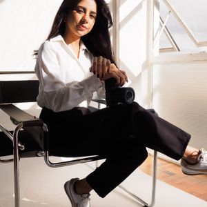 Wide shot of a minimalist studio space with natural light.